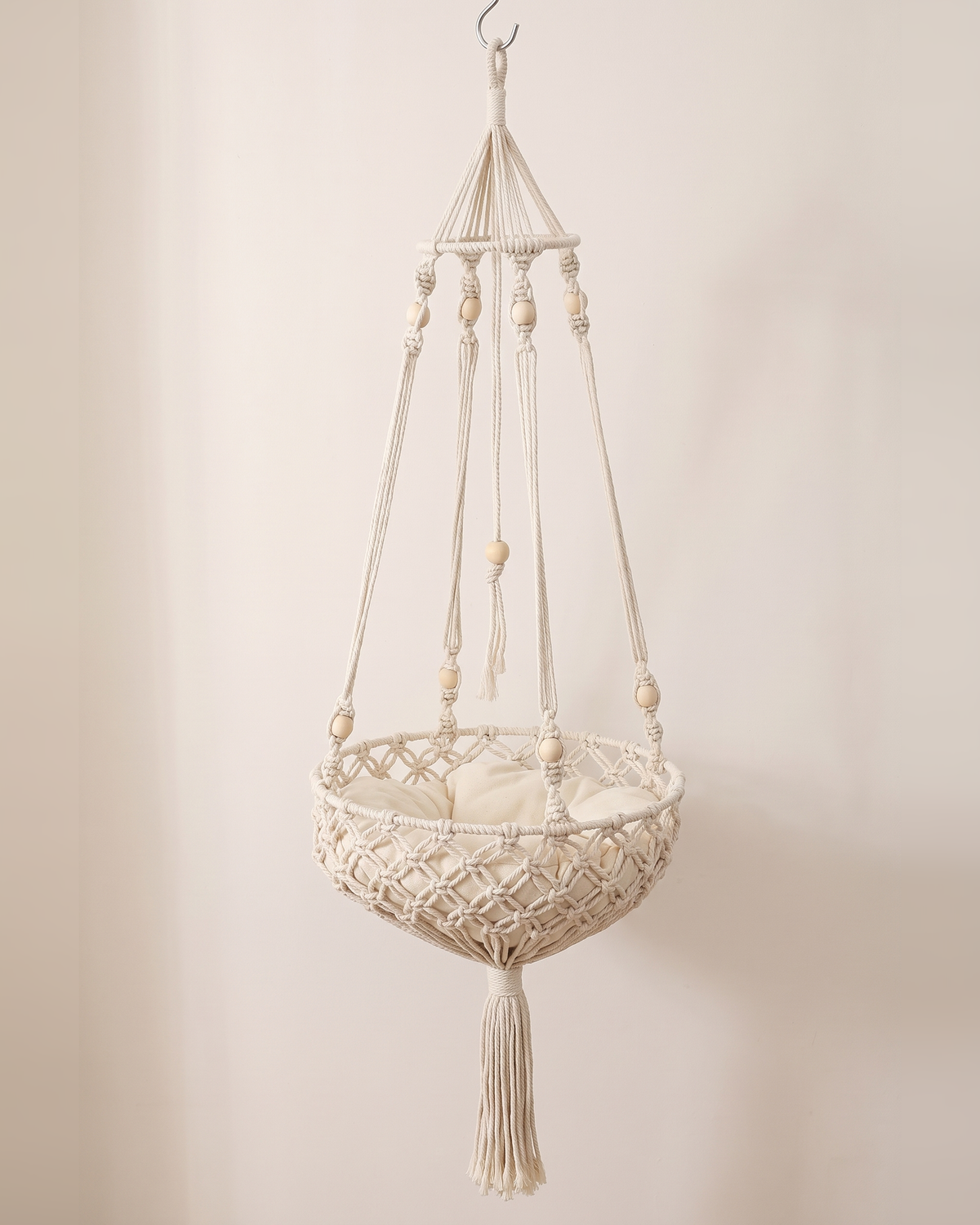 The Cloudpurr macramé hanging cat bed on its own, cream rope, wooden beads and cushion