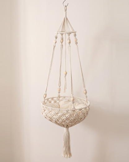 The Cloudpurr macramé hanging cat bed on its own, cream rope, wooden beads and cushion
